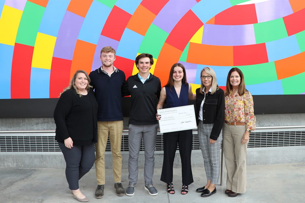 Students and Pappajohn staff holding a competition award check.