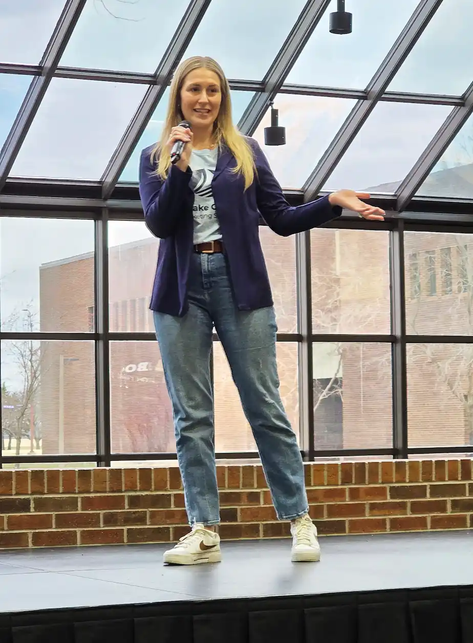 A woman standing on a stage and pitching her business idea